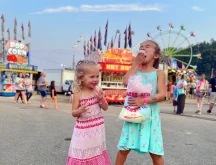 two young girls eating cotton candy at the Knox County Fair