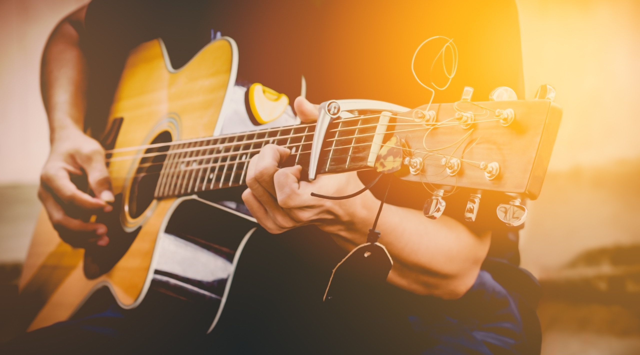 Photo of a guitarist playing their instrument.